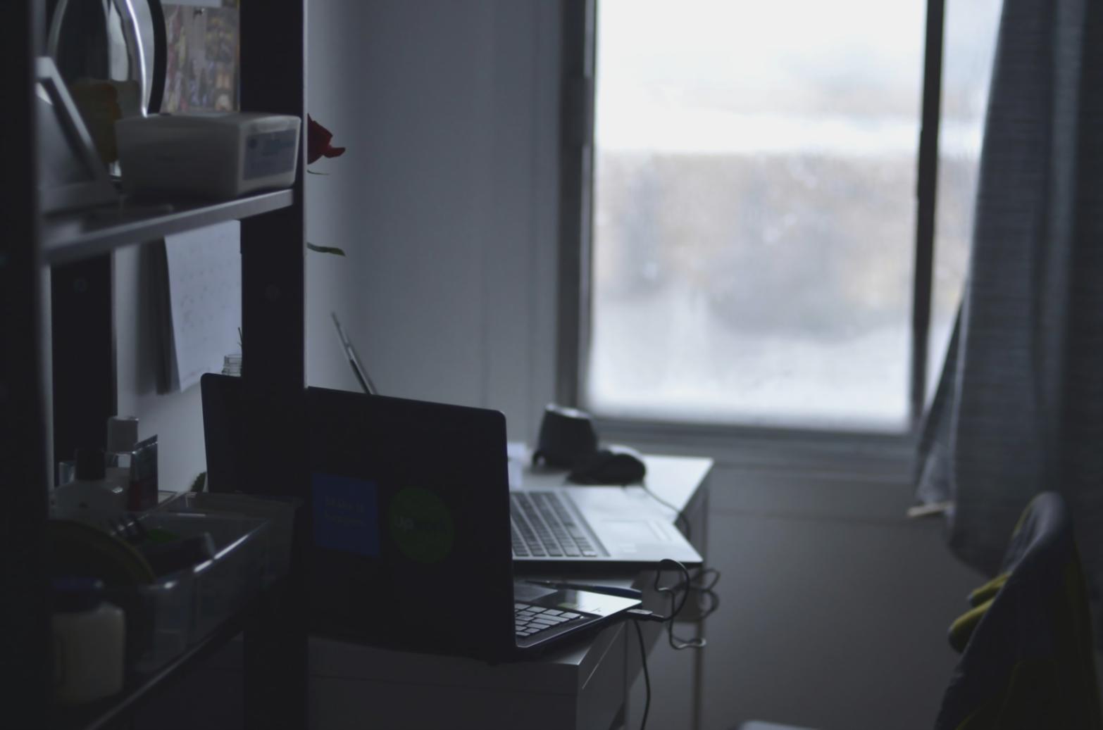 Student reviewing budget reports and financial analysis documents during workshop session